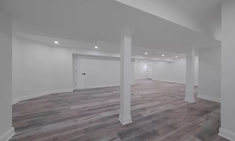 Basement with hardwood / wood-style floors