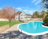 View of swimming pool with a lawn and a patio