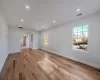 Unfurnished room with light wood-type flooring and a chandelier