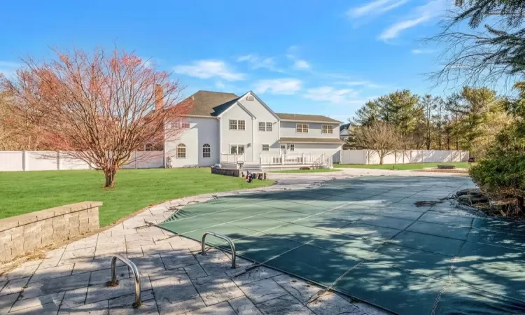 View of sport court with a patio area, a yard, and a covered pool