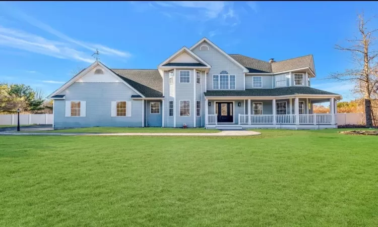 View of front of home with a porch and a front yard