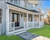 Doorway to property featuring a yard and covered porch