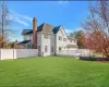 Back of property featuring a lawn and a garage