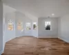 Spare room with light hardwood / wood-style flooring and vaulted ceiling