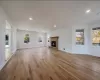 Unfurnished living room with light hardwood / wood-style flooring and a brick fireplace