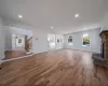 Unfurnished living room with a fireplace, a notable chandelier, and hardwood / wood-style floors