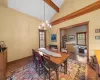 Dining space with beamed ceiling, high vaulted ceiling, an inviting chandelier, and a healthy amount of sunlight