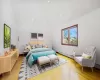 Bedroom featuring light hardwood / wood-style flooring and a baseboard heating unit