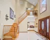 Entryway with high vaulted ceiling and light tile patterned flooring