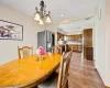 Dining area with light tile patterned flooring and an inviting chandelier