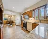 Kitchen featuring sink, decorative light fixtures, backsplash, and appliances with stainless steel finishes