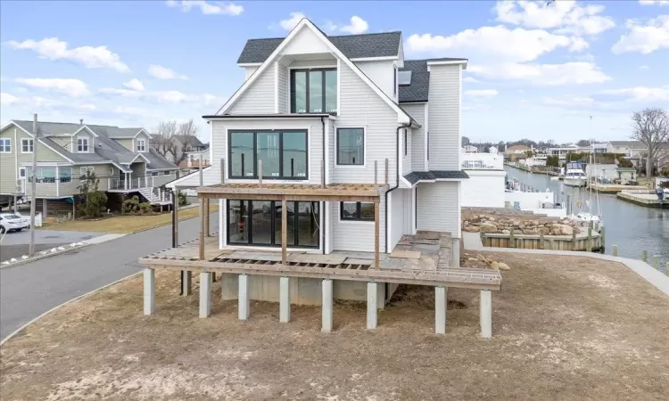 Back of house featuring a water view