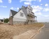 View of property exterior with a garage and a porch