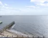 Dock area with a water view and a view of the beach