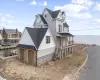 View of side of home with a porch and a water view