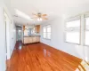 Kitchen featuring ceiling fan, hanging light fixtures, white refrigerator, and hardwood / wood-style flooring