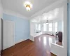 Unfurnished living room with dark hardwood / wood-style flooring and radiator