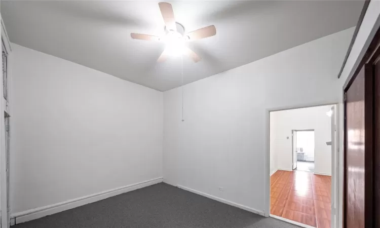 Carpeted empty room with ceiling fan