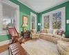 Living room featuring built in bookcases flanking wood burning fireplace