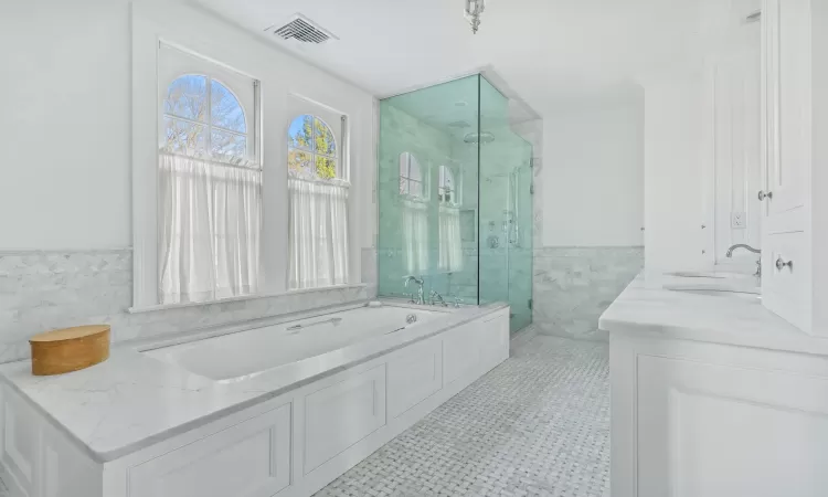 Dining room featuring a notable chandelier, hardwood / wood-style floors, crown molding, and plenty of natural light