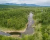 Drone / aerial view featuring a water and mountain view