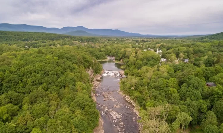 Drone / aerial view with a water and mountain view