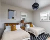 Bedroom featuring hardwood / wood-style floors, cooling unit, and crown molding