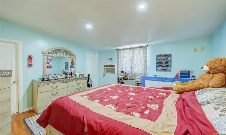 Bedroom with light hardwood / wood-style flooring