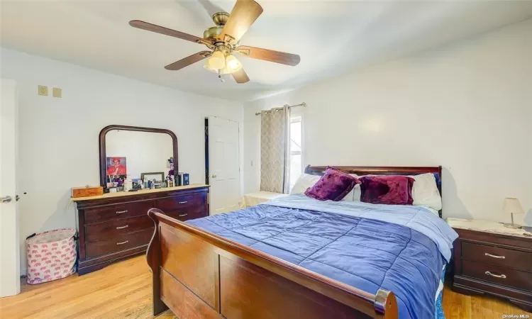 Bedroom with ceiling fan and light hardwood / wood-style floors