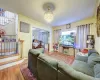 Living room with an inviting chandelier and wood-type flooring