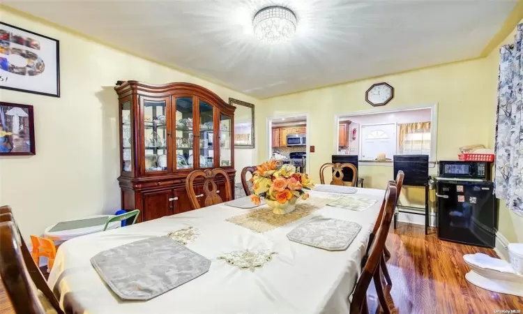 Dining area featuring dark hardwood / wood-style flooring and a chandelier