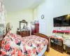 Bedroom featuring lofted ceiling and light hardwood / wood-style floors