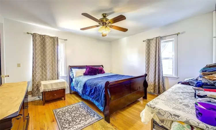 Bedroom featuring ceiling fan and light hardwood / wood-style flooring