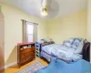 Bedroom featuring ceiling fan and light hardwood / wood-style flooring