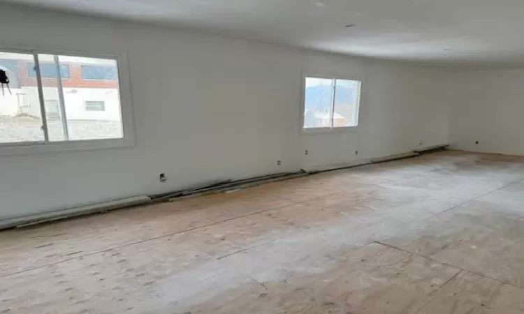 Unfurnished room featuring a wealth of natural light