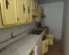 Kitchen with electric stove, sink, and white dishwasher