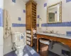 Bathroom with tile walls, toilet, tile patterned floors, and sink