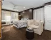 Carpeted bedroom with ornamental molding and ceiling fan