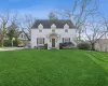 Cape cod-style house with a front lawn