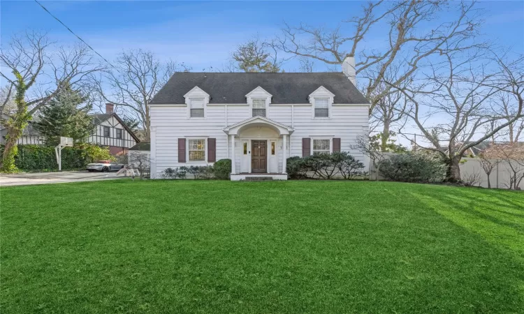 Cape cod-style house with a front lawn