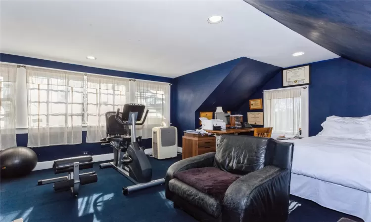 Workout area with lofted ceiling and a healthy amount of sunlight