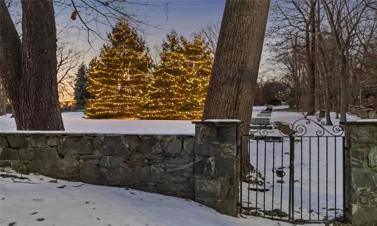 View of snow covered gate and stonewall