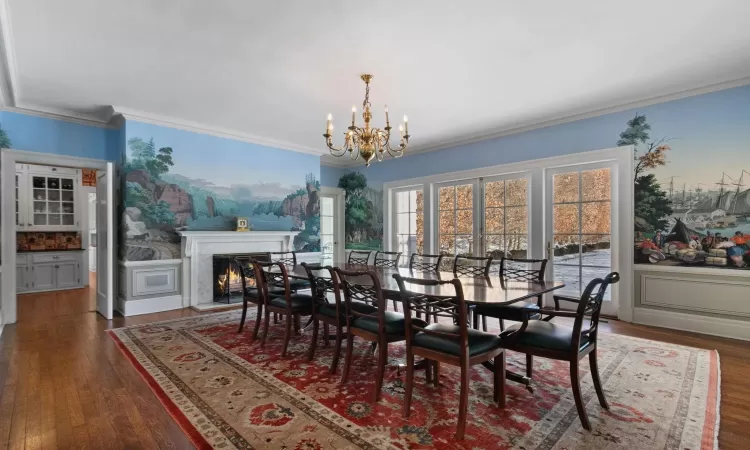 Formal Dining Room with Zuber panels, fireplace, and a chandelier