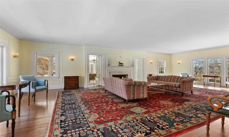 Large living room featuring a fireplace and double front and back French doors out to patio