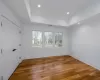 Spare room featuring hardwood / wood-style floors and a tray ceiling