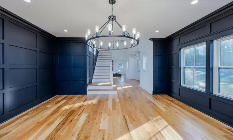 Unfurnished dining area featuring a chandelier and light hardwood / wood-style floors