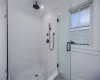 Bathroom featuring an enclosed shower and crown molding