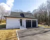 View of front of home with a garage and a front yard