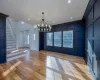 Unfurnished dining area featuring crown molding, light hardwood / wood-style flooring, and a notable chandelier