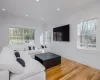 Living room featuring crown molding and hardwood / wood-style flooring